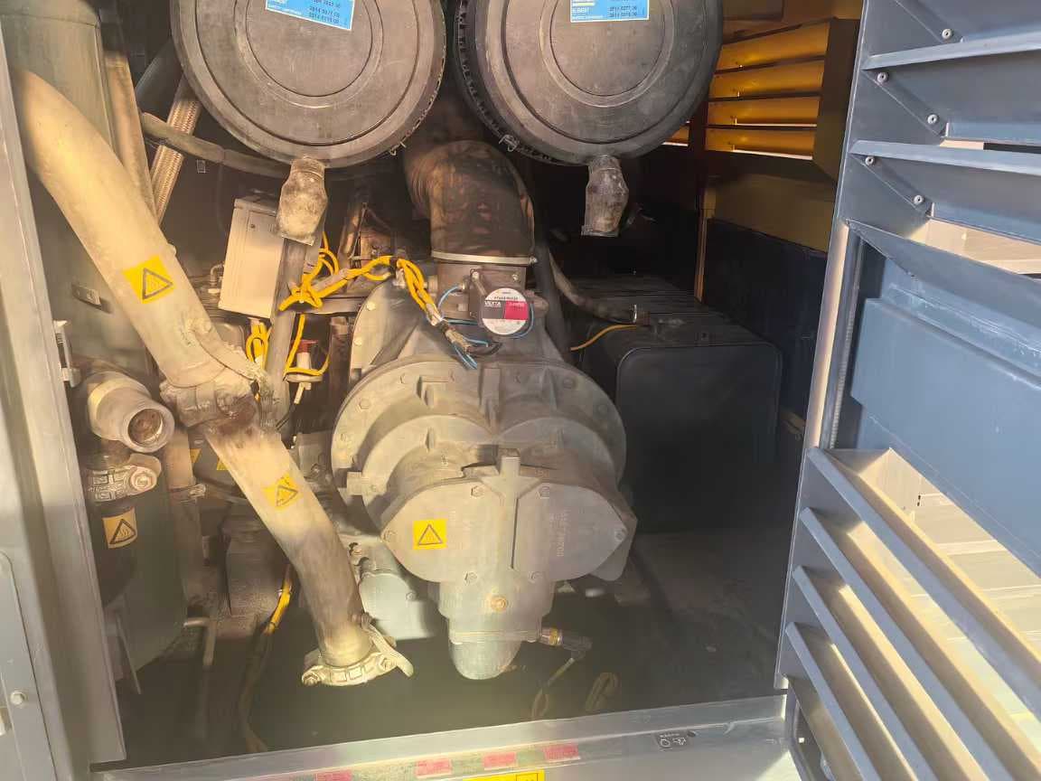 Open service compartment showing the compressor element and connected pipework