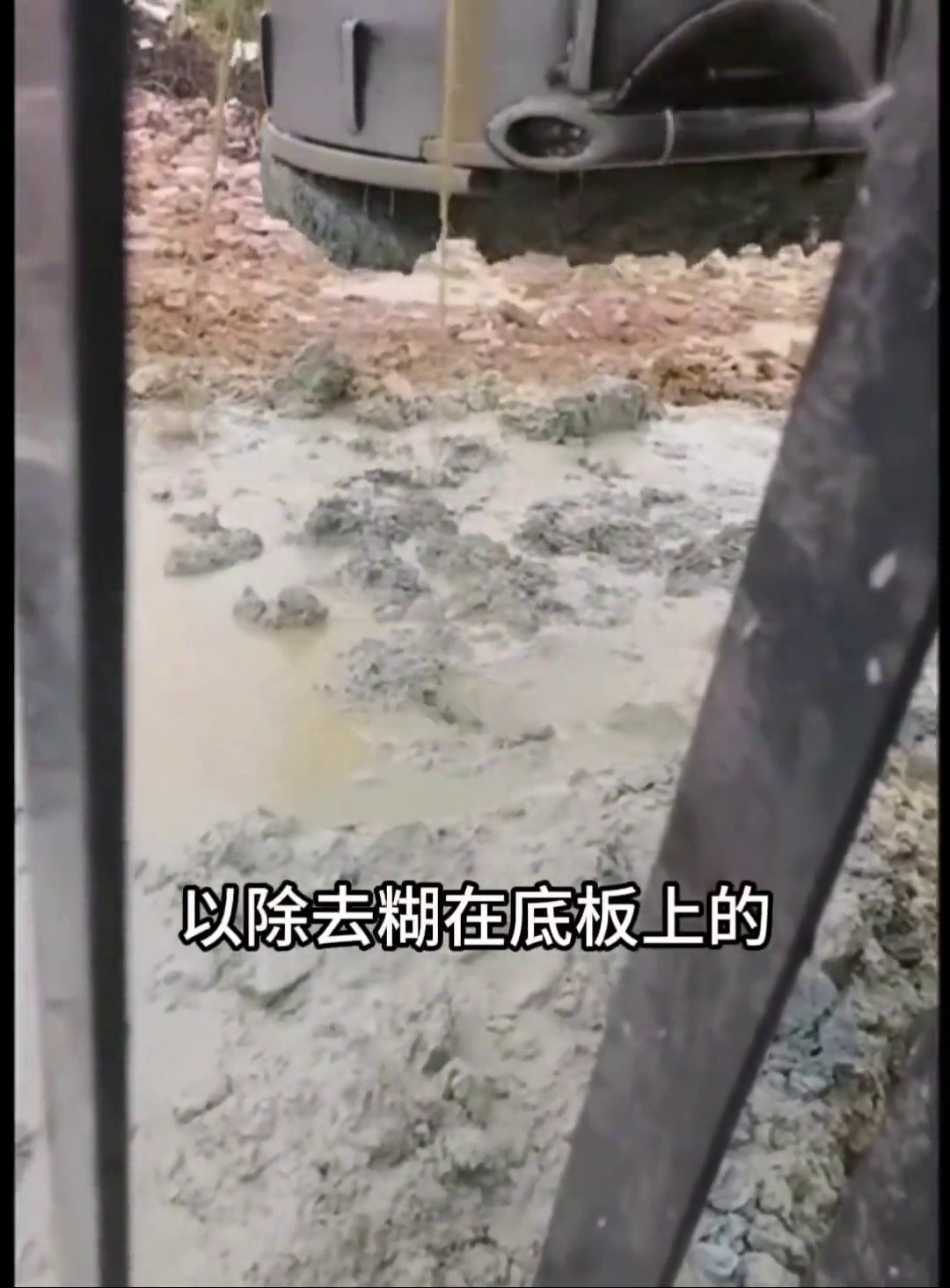 Removing caked clay from the bucket before another pass